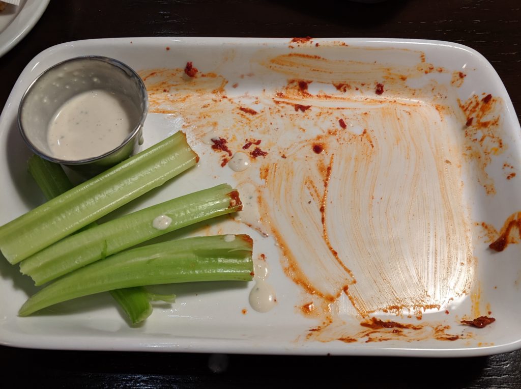 empty plate of no refund hot wings at macs proper pub